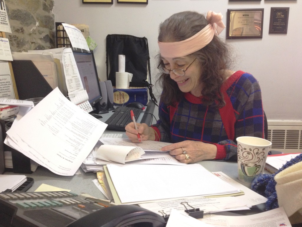 Judy Noy, the Norwood News' prolific proofreader, doing what she does best--proofing! by David Cruz 