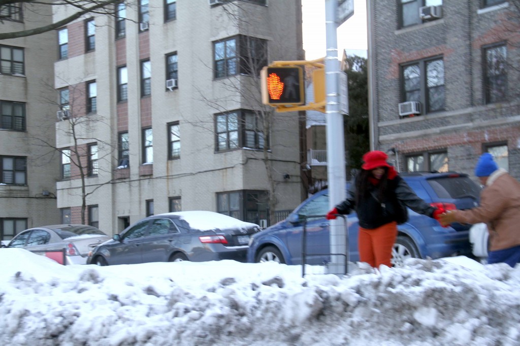 Neighbors carefully walk along mountains of icy snow during this winter that won't end. Photo by David Greene