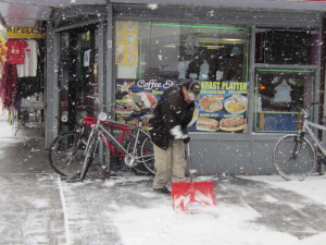 THIS WORKER SHOVELS outside New Star Coffee Shop. Photo by David Cruz