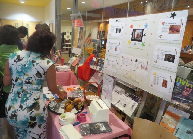 A WOMAN STOPS by the informational tables containing breastfeeding pamphlets and giveaways during Montefiore's "World Breastfeeding Week Celebration." Photo by Jasmine Gomez