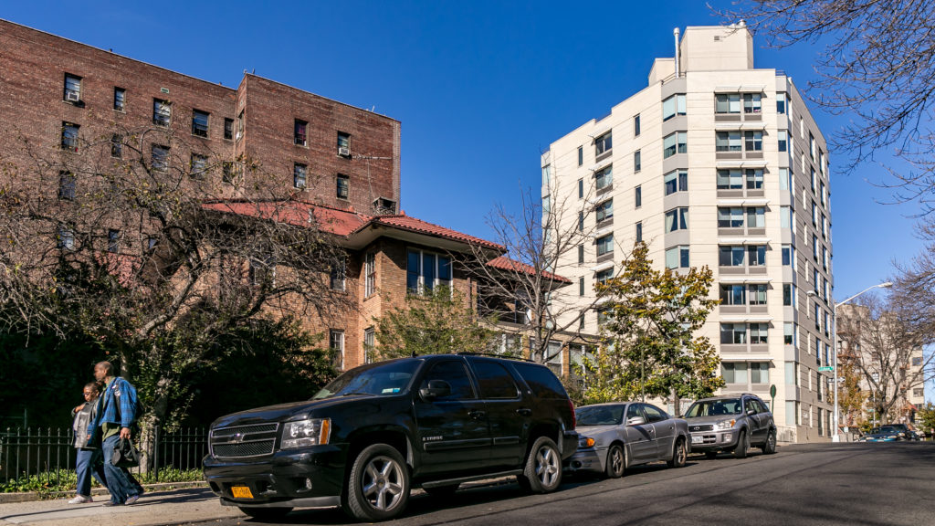 PRESERVING THIS SECTION of Bedford Park is the subject of an independent study by Community Board 7. Here, an apartment building at East 205th Street and Steuben Avenue is feet from a private home. Photo by Adi Talwar